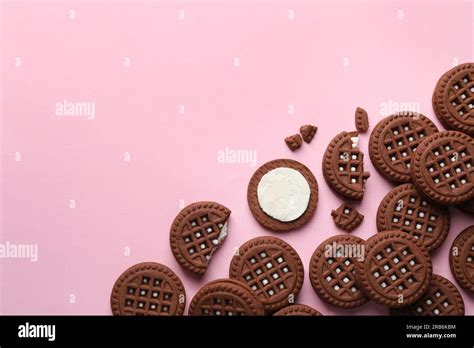 Tasty Chocolate Sandwich Cookies With Cream On Pink Background Flat