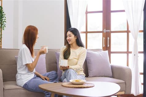 Premium Photo Activity At Home Concept LGBT Lesbian Sitting On Couch And Drinking Coffee While