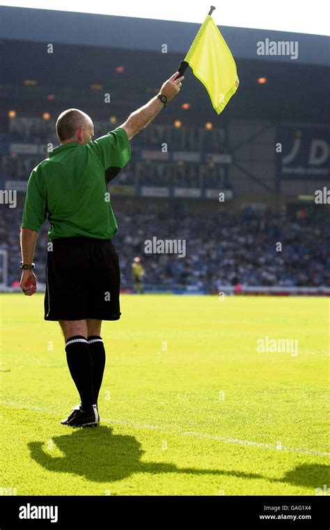 The Assistant Referee Raises His Flag For An Offside Hi Res Stock