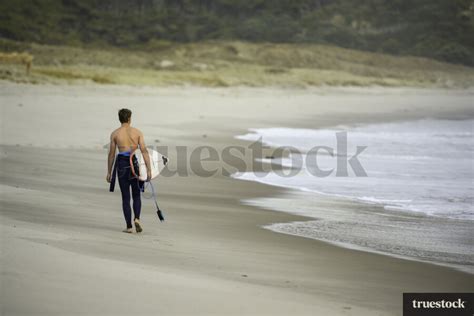 Surfing at the Beach by Jay Drew - Truestock