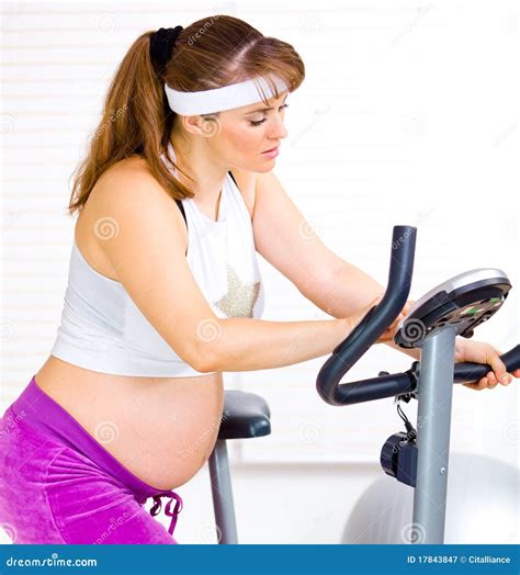 Pregnant Preparing for Workout on Stationary Bike Stock Image - Image