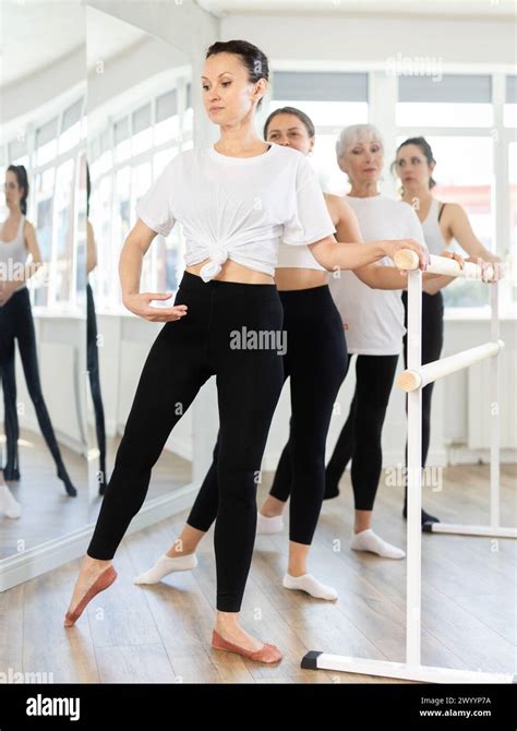 Graceful Women Of Different Ages Practice At Ballet Stand In Fifth