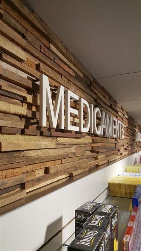 the sign on the wall is made out of wood planks and reads medicaments