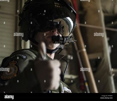 A No 40 Squadron Royal New Zealand Air Force Loadmaster Looks Out The