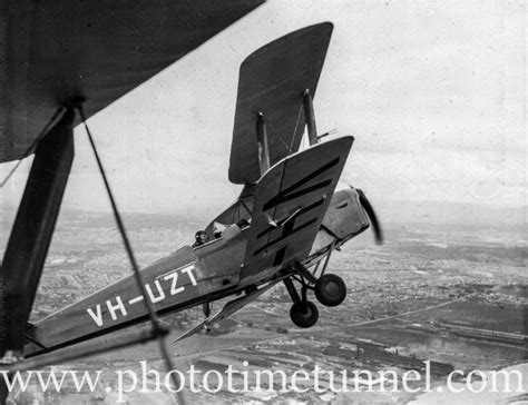 Tiger Moth aircraft over Newcastle, NSW, circa 1940s, showing BHP steelworks. - Photo Time Tunnel