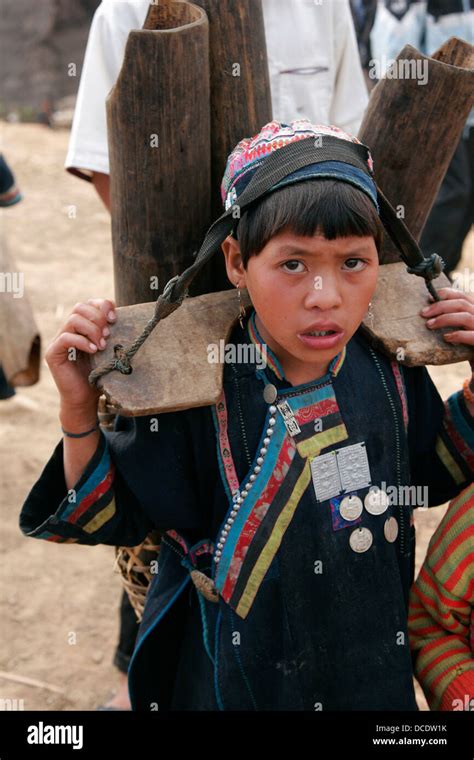 Young Akha Girl Carrying Heavy Load In Tribal Village Near Phongsali