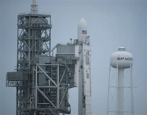 Photos Falcon Booster Minus Landing Legs And Grid Fins Poised For