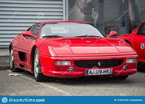 Front View Of Red Ferrari F Berlinetta Parked In The Street