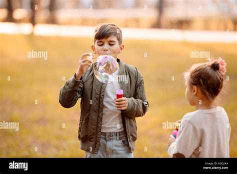 Boy Blowing Soap Bubbles Stock Photo Alamy