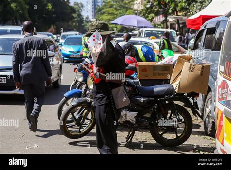 A Kenyan Man Uses His Phone To Request For A Boda Boda Motor Cycle