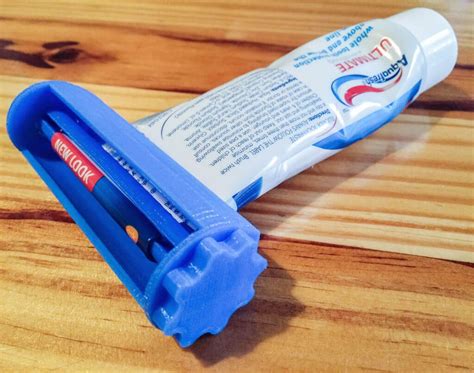 A Tube Of Toothpaste Sitting On Top Of A Wooden Table