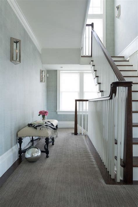 Second Floor Landing Boasts Polished Nickel And Glass Sconces On Blue