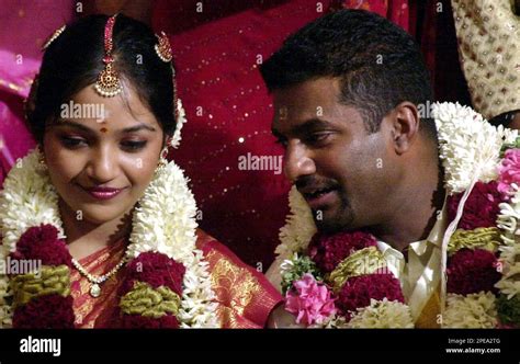 Sri Lankan cricketer Muttaiah Muralitharan, right, talks to his wife ...