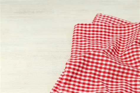 Premium Photo | Red and white checkered tablecloth on white wooden ...