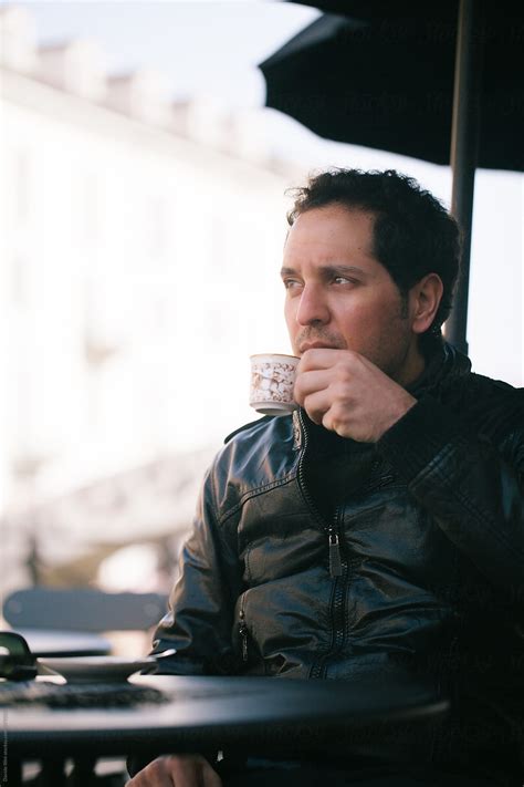 Young Man Drinking Coffee Outdoors By Stocksy Contributor Davide