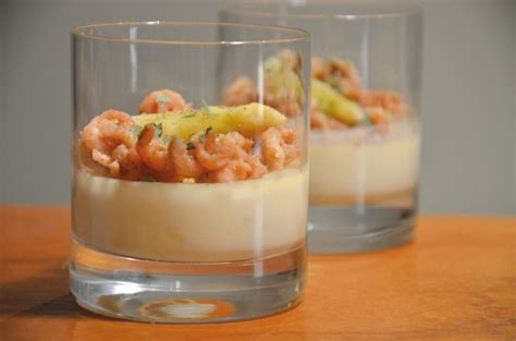 Two Glasses Filled With Food On Top Of A Wooden Table