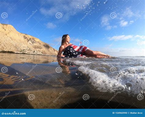 A Lovely Brunette Model Poses Nude At The Coast With An American Flag Stock Photo Image Of