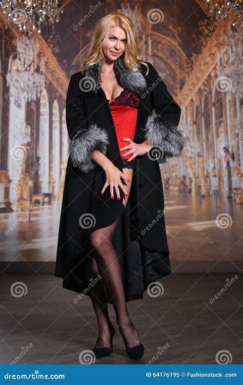 Fashion Seductive Blond Hair Lady In An Elegant Fur Coat Red Lingerie And Stockings Stock Image