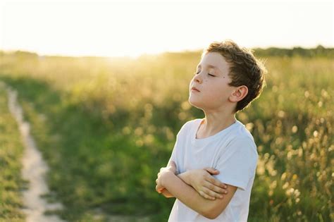 Premium Photo Boy Closed Her Eyes And Praying In A Field At Sunset