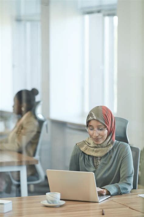 Woman Using a Laptop in the Office · Free Stock Photo