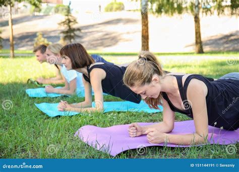 Group Of Young Sporty People Doing Exercise Outdoors Stock Image