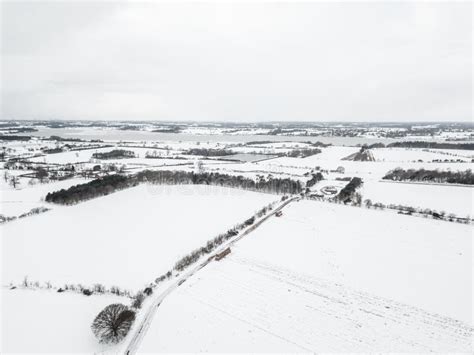 Aerial View Of Snow Covered Farm Fields In The British Countryside