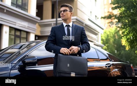 Successful businessman standing near luxury car, social welfare, life ...