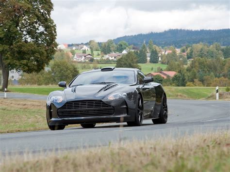 Black Sports Car On Gray Concrete Road During Daytime HD Wallpaper