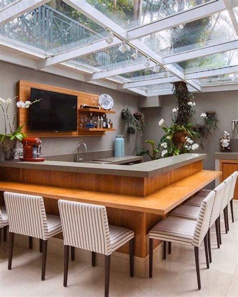 A Large Kitchen With An Island And Skylights Above The Counter Top