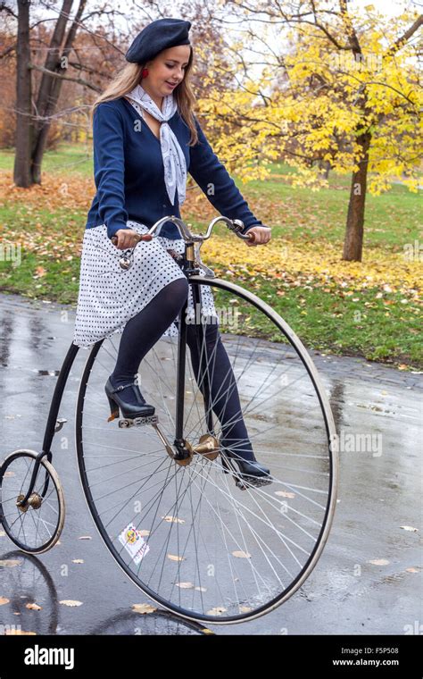 Woman in traditional Penny Farthing bicycle race.Prague Letna Park ...