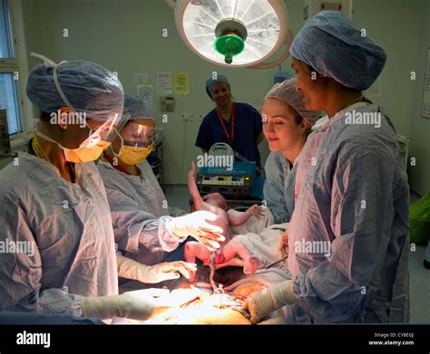 A baby boy being born by Cesarean section by operating staff from Kings ...