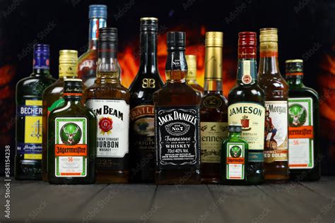 KYIV, UKRAINE - MAY 4, 2022 Many new bottles of worldwide popular alcohol brands of whiskey ...