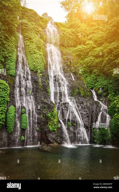 Jungle Waterfall Cascade In Tropical Rainforest With Rock And Turquoise