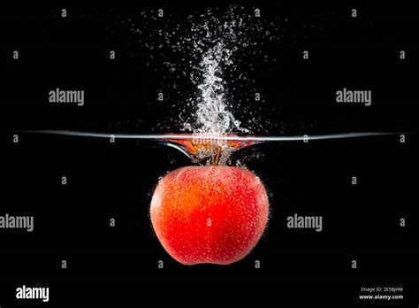 Red Apple Falling Into Splashing Water Stock Photo Alamy