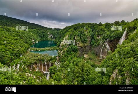 An aerial view of the lake and lush greenery of Plitvice Lakes National ...