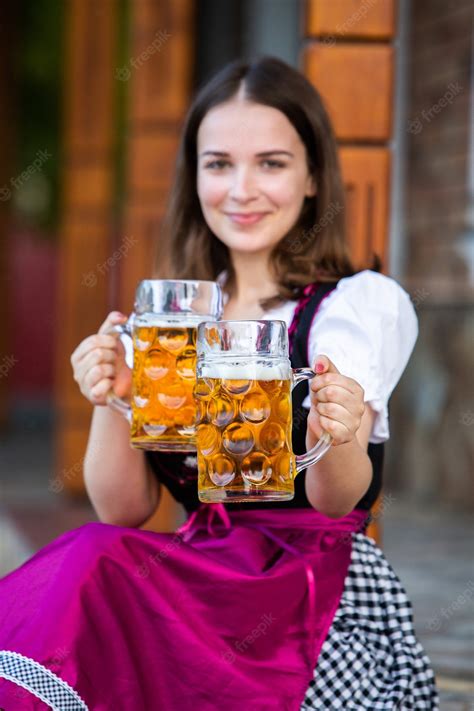 Premium Photo Sexy Russian Woman In Bavarian Dress Holding Beer Mugs