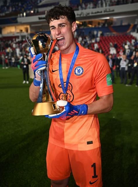 The Soccer Player Is Holding His Trophy In One Hand And Making A Face