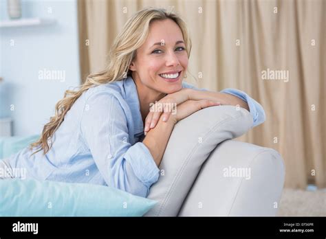 Cheerful Pretty Blonde Sitting On Couch Stock Photo Alamy