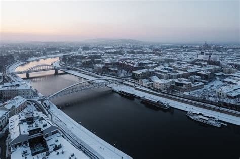 Aerial View of a Snowy City Landscape Featuring a River Meandering ...