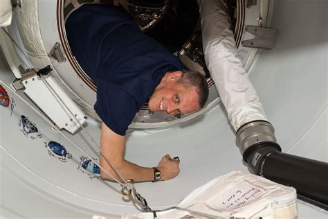 Astronaut Bob Hines Signs His Name Around The Crew Mission Insignia