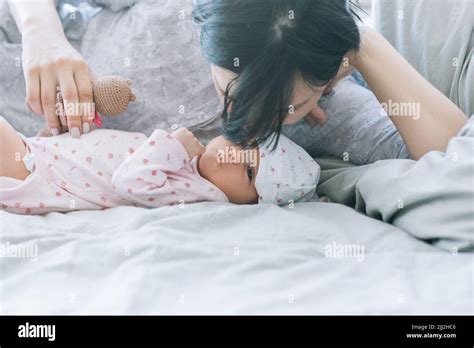 Mom with pleasure sniffing her newborn baby Stock Photo - Alamy