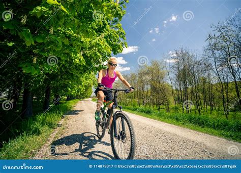 Woman Cycling A Mountain Bike In City Park Summer Day Stock Image