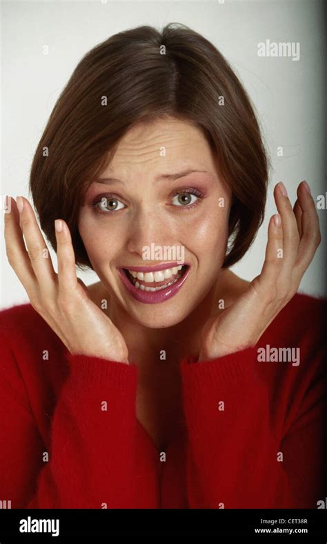 Female Short Brunette Hair Wearing A Red Jumper Scared Facial