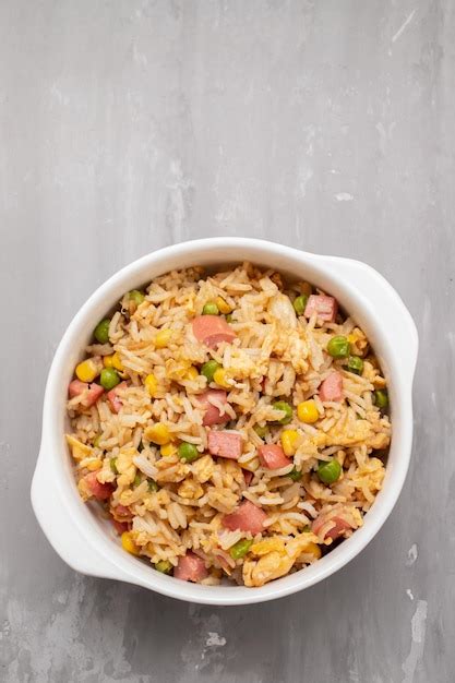 Premium Photo | Rice with corn peas ham on white bowl