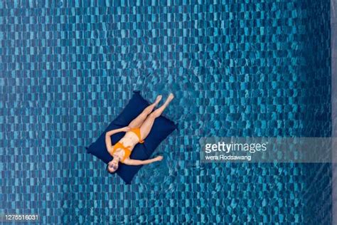 170 Woman Lying On Pool Raft In Swimming Pool Stock Photos High Res