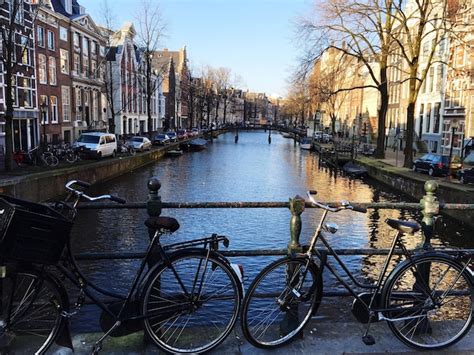 Premium Photo Bikes Parked In Front Of Canal