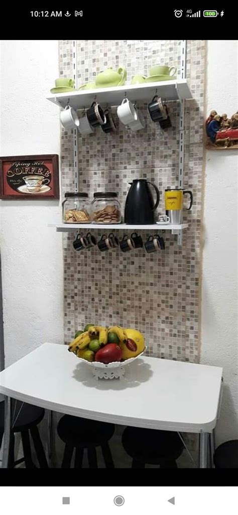 A Bowl Of Fruit Sitting On Top Of A Table Next To A Wall Mounted Shelf