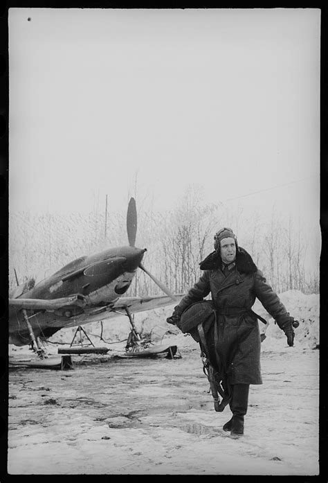 A Fighter Pilot With A Parachute Lagg 3 Aircraft On A Ski Chassis Is