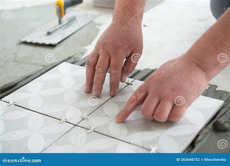 Tiler Laying The Ceramic Tile On The Floor Professional Worker Makes