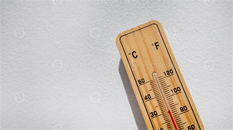 Wooden thermometer showing high temperature, symbolizing heatwaves